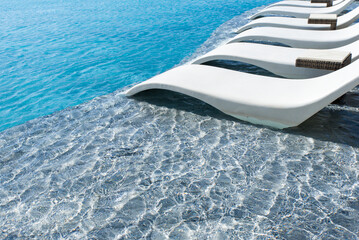 Sun beds on the swiming pool