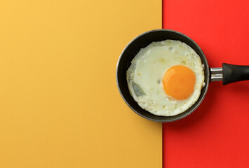 Sunny SIde Egg on Mini Pan Above Yellow and Red Table