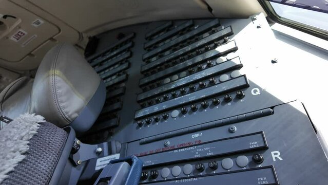 Inside an airplane cabin. Upward closeup view of the rear clircuit breaker panels. 4K