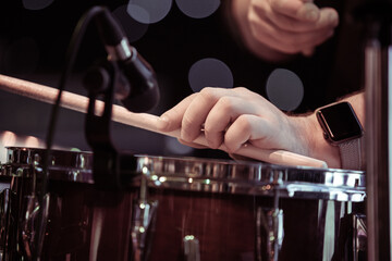 Hands of a musician playing drums close-up