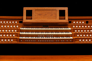 Church organ keyboard on black background