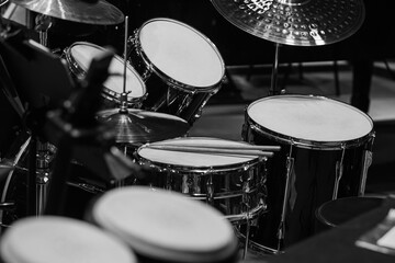 Fototapeta na wymiar Fragment of a drum kit on stage in black and white