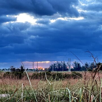 Stormy sky and sunset in the clouds over the swamp landscape