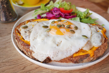 Avocado egg sandwich served with salad on a plate 