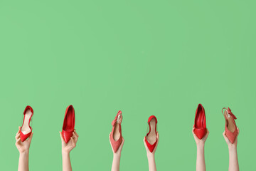 Women with red heels on green background