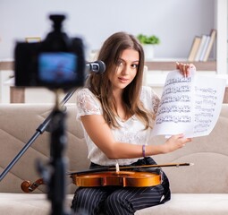 Fototapeta na wymiar Female beautiful blogger playing violin