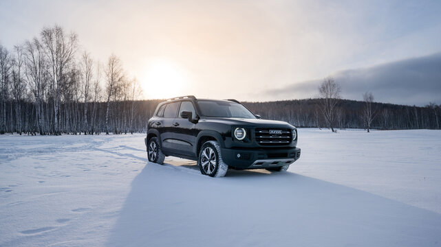 Helsinki, Finland - February 02, 2023 Haval Dargo black in a snowy field in winter.
