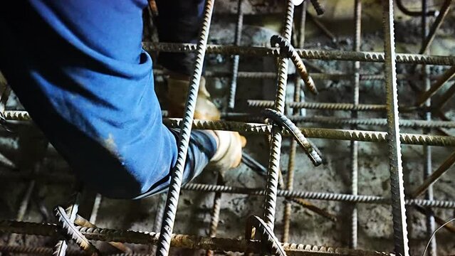 worker assembles rebar at tunnel station construction