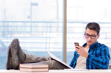 Student studying in the empty library with book preparing for ex
