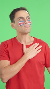 Man listening to the Costa Rica national anthem with solemnity