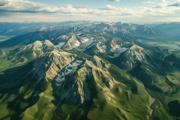 Wandcirkels plexiglas Mountains are covered in snow and are seen from an airplane © Roman