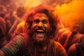 happy indian man in the foreground in front of happy hindu indian people celebrate holi festival by...