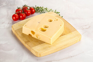 Maasdam cheese brick over board