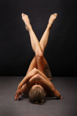Abstract sport and medical concept. Beautiful body of yoga woman over dark background.