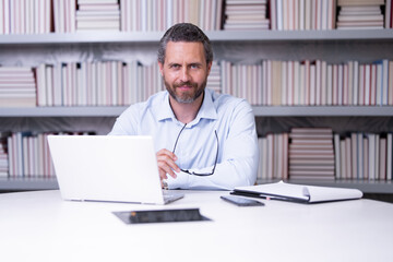 Fototapeta premium Teachers day. Teacher in school classroom. Knowledge and education with middle aged teacher. Millennial teacher with book. Man teaching lesson in class. Teachers from university exam. College teacher.
