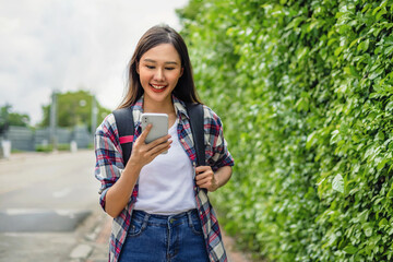 portrait of  woman with mobile phone  and smile at park