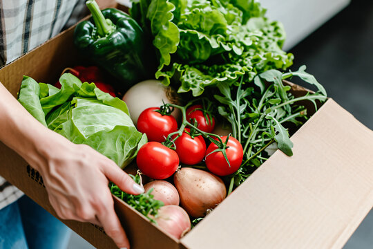 photo close up of box with vegetables in hands