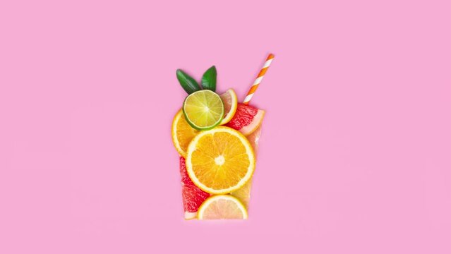 Creative flat lay juice concept. Sliced citrus orange, lime, grapefruit, lemon, fruits make juice glass shape. Stopmotion animation, video, footage 4k flat lay