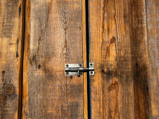 Wooden barn door closed on metal latch