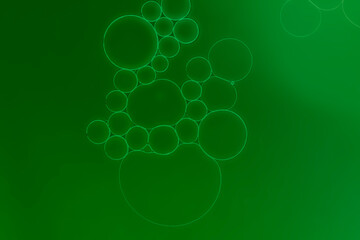 Green abstract background. Oil and water droplets on surface theme.
