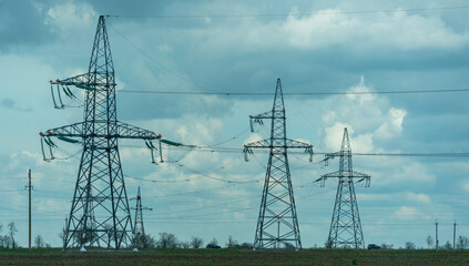 High voltage towers with sky background. Power line support with wires for electricity transmission. High voltage grid tower with wire cable at distribution station. Energy industry, energy saving