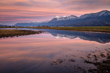 Pink sky and reflection of snowy mount cheam in Chilliwack, Canada