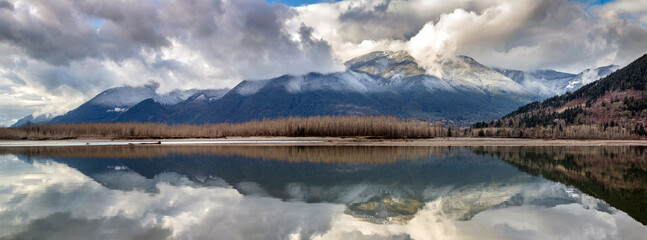 Panoramic view of snowy mountains and the Fraser River at Island 22 in Chilliwack, BC, Canada