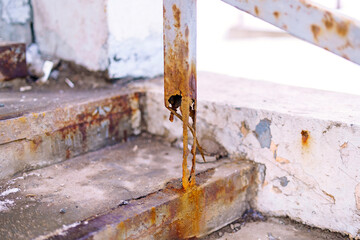 The metal support beam is completely corroded