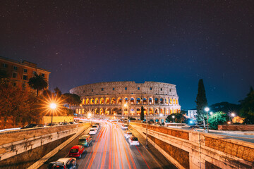 Rome, Italy. Bold Bright Dark Blue Night Starry Sky With Glowing Stars Above Colosseum Also Known As Flavian Amphitheatre In Evening Or Night Time. Travel To Italy.
