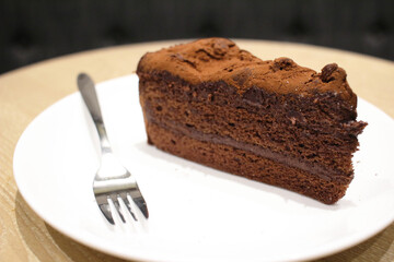 A Dark chocolate cake at white plate