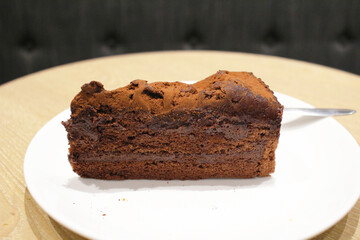 A Dark chocolate cake at white plate