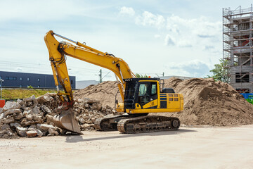 Fototapeta na wymiar yellow excavator on a construction site. Also called diggers, JCB, mechanical shovels, or 360-degree excavators