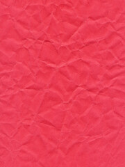 Fototapeta premium Texture of colored paper, sheet of crumpled dark red paper