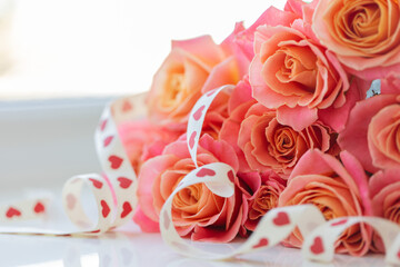 Bouquet of roses with gift ribbon. Closeup. Floral gift.
