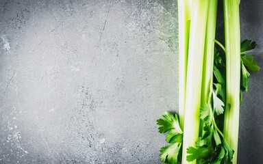 A stalk of fresh celery on the table. On a gray background