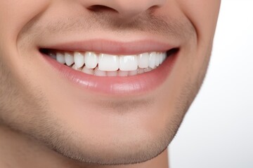 close-up of a man's perfectly white teeth and charming smile, promoting advances in the field of dentistry or orthodontics.