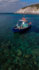 Obraz premium Aerial view of Cala Sapone, S. Antioco bay in Sardinia. Crystal clear sea, moored boat and white sand.
