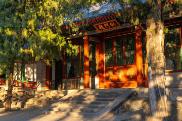 A traditional upper class Chinese house with stone staircase, two red pillars, and red entrance,...