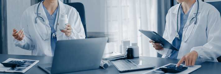 Healthcare And Medicine concept. Doctor working with laptop and tablet at table office.