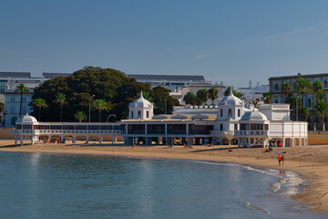 Fototapeta na wymiar view of la caleta beach with white building of an old bathhouse in the spanish city cadiz