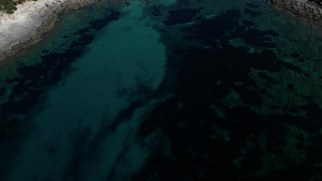 Aerial view of Cala Sapone, S. Antioco bay in Sardinia. Crystal clear sea, moored boat and white sand.
