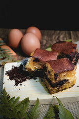 Chocolate sweet Indonesian thick-folded crepe or Martabak manis/Terang Bulan food photography with tropical leaves