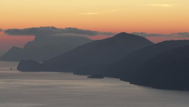 wonderful sunset from the Path of the Gods on the Amalfi Coast with a view of Capri and the Faraglioni and the Li Galli islet
