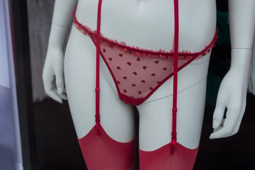closeup of red underwear with little hearts on mannequin in a fashion store showroom - obrazy, fototapety, plakaty