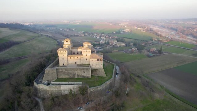 Orbit flying over Torrechiara Castle panoramic view. Parma, Italy.
