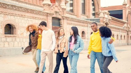 Multi-ethnic friends strolling together relaxed in the city