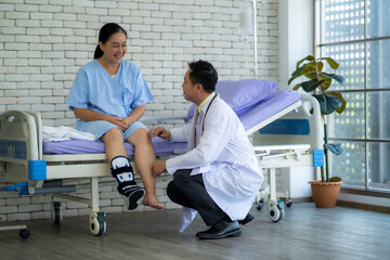 The doctor is examining a patient with a foot injury and a broken leg.