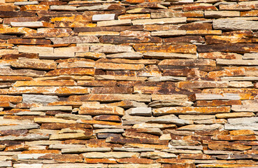 A wall of stacked stone pieces