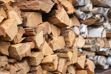 Stacked firewood. Preparation of firewood for the winter. Stocks of wooden firewood. Stacked firewood. Village lifestyle.