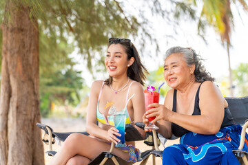Happy Asian family enjoy outdoor lifestyle travel ocean on summer holiday vacation. Woman and...